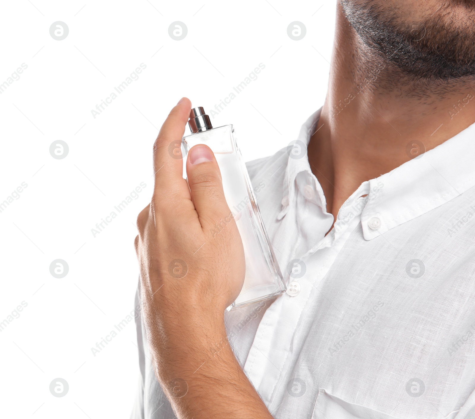 Photo of Young man applying perfume on white background, closeup