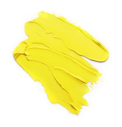 Photo of Yellow oil paint strokes on white background, top view