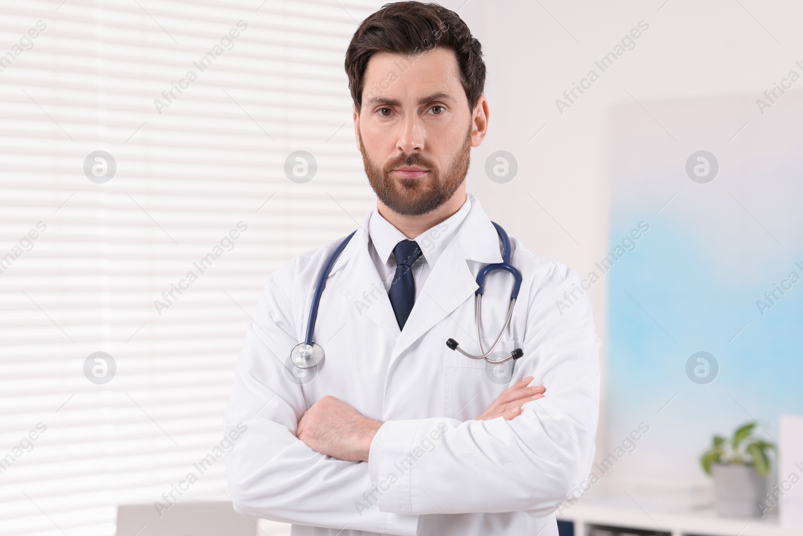 Photo of Portrait of medical consultant with stethoscope in clinic