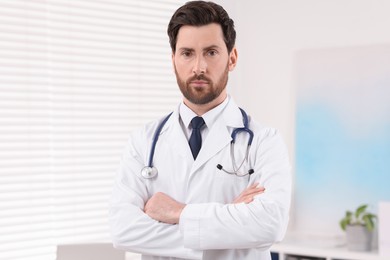 Photo of Portrait of medical consultant with stethoscope in clinic