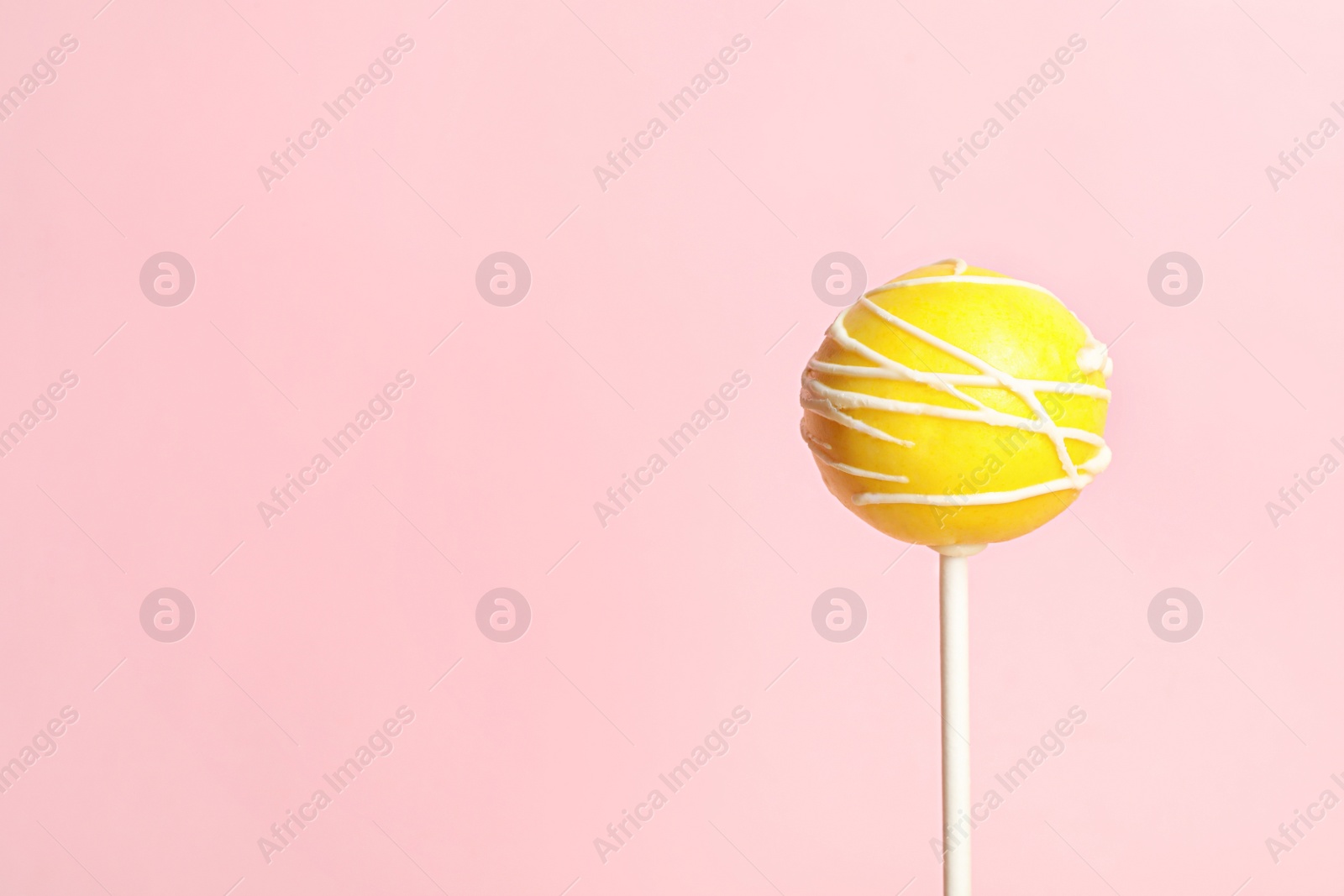 Photo of Bright delicious cake pop on color background. Space for text