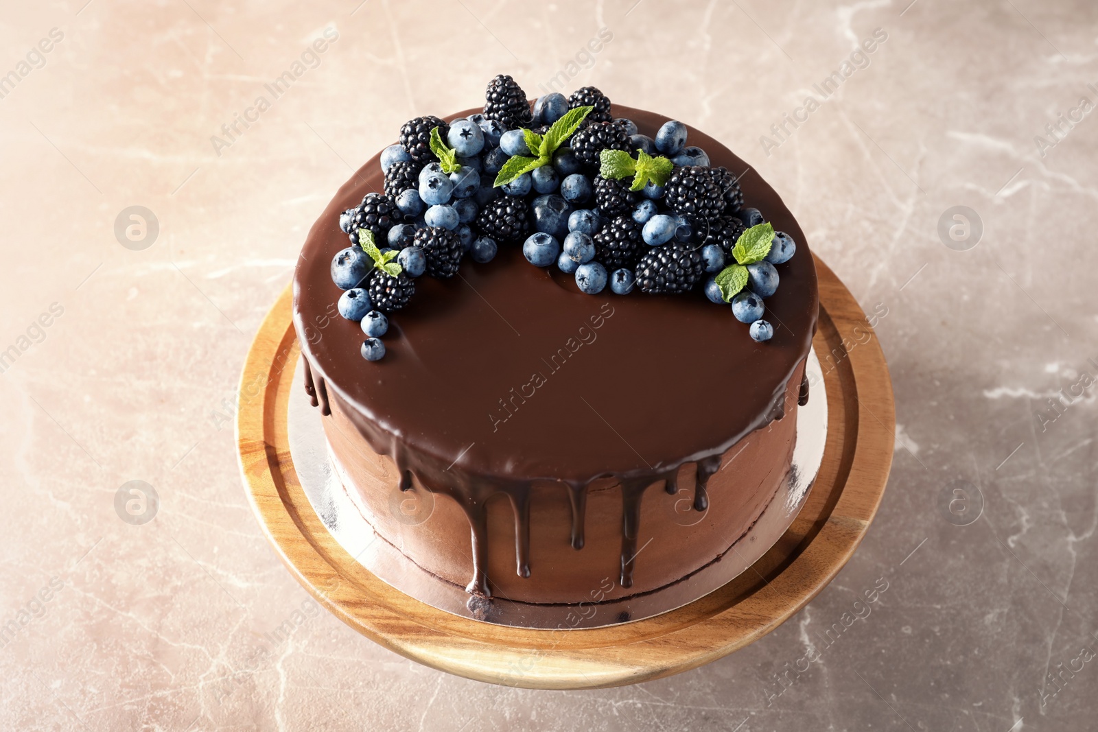 Photo of Fresh delicious homemade chocolate cake with berries on table