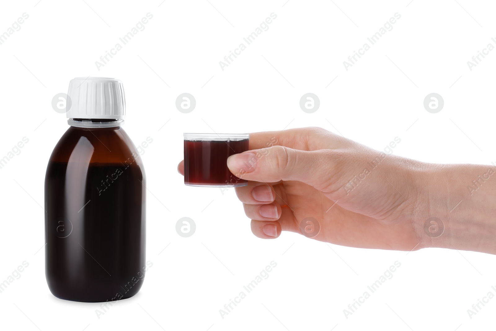 Photo of Woman holding measuring cup with syrup isolated on white, closeup. Cough and cold medicine