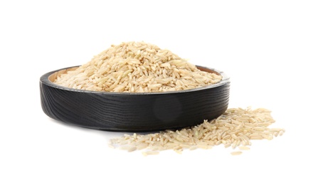 Plate with raw unpolished rice on white background