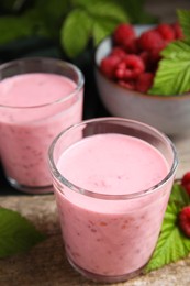 Photo of Tasty raspberry smoothie and fresh berries on wooden table, closeup