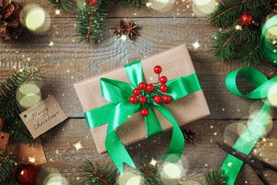 Image of Flat lay composition with Christmas gift box and fir tree branches on wooden table