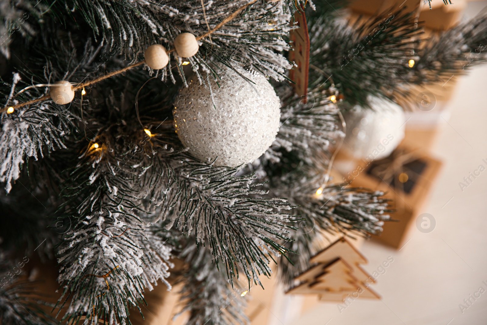 Photo of Beautiful decorated Christmas tree with fairy lights in room, closeup