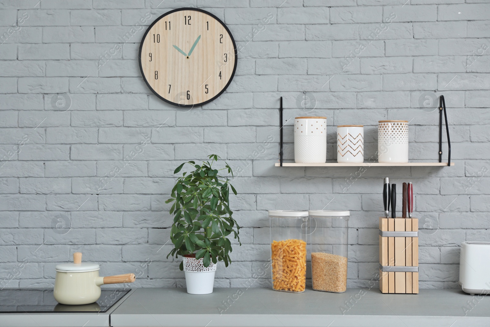 Photo of Modern kitchen interior with new furniture and different utensils