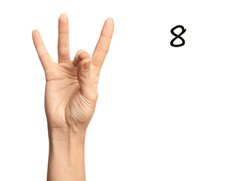Woman showing number eight on white background, closeup. Sign language
