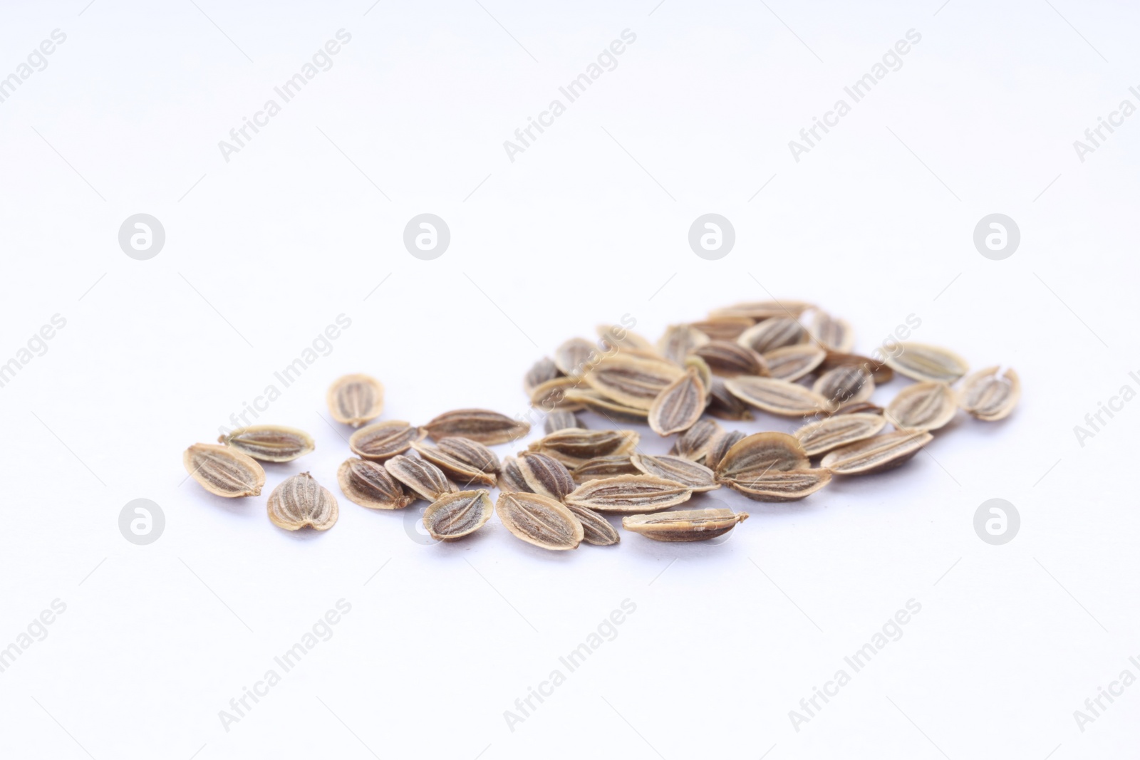 Photo of Many dry dill seeds isolated on white