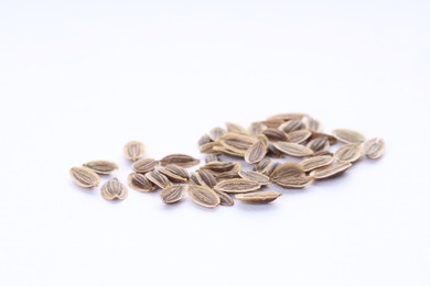 Many dry dill seeds isolated on white