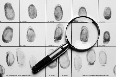 Photo of Criminal fingerprint card and magnifier, top view