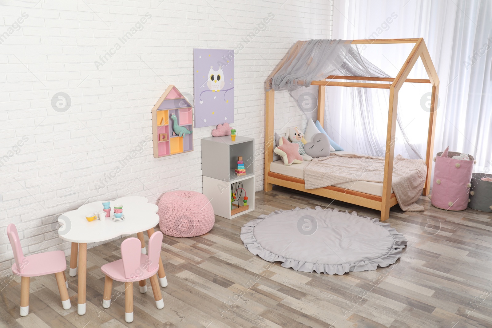 Photo of Cute child's room interior with toys and modern furniture