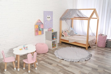 Cute child's room interior with toys and modern furniture