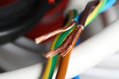 Photo of Colorful electrical wires on blurred background, closeup