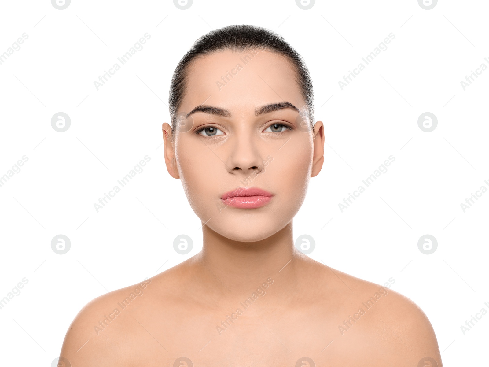 Photo of Portrait of young woman with beautiful face and natural makeup on white background
