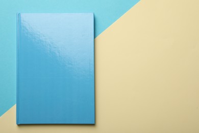 Photo of New light blue planner on color background, top view. Space for text