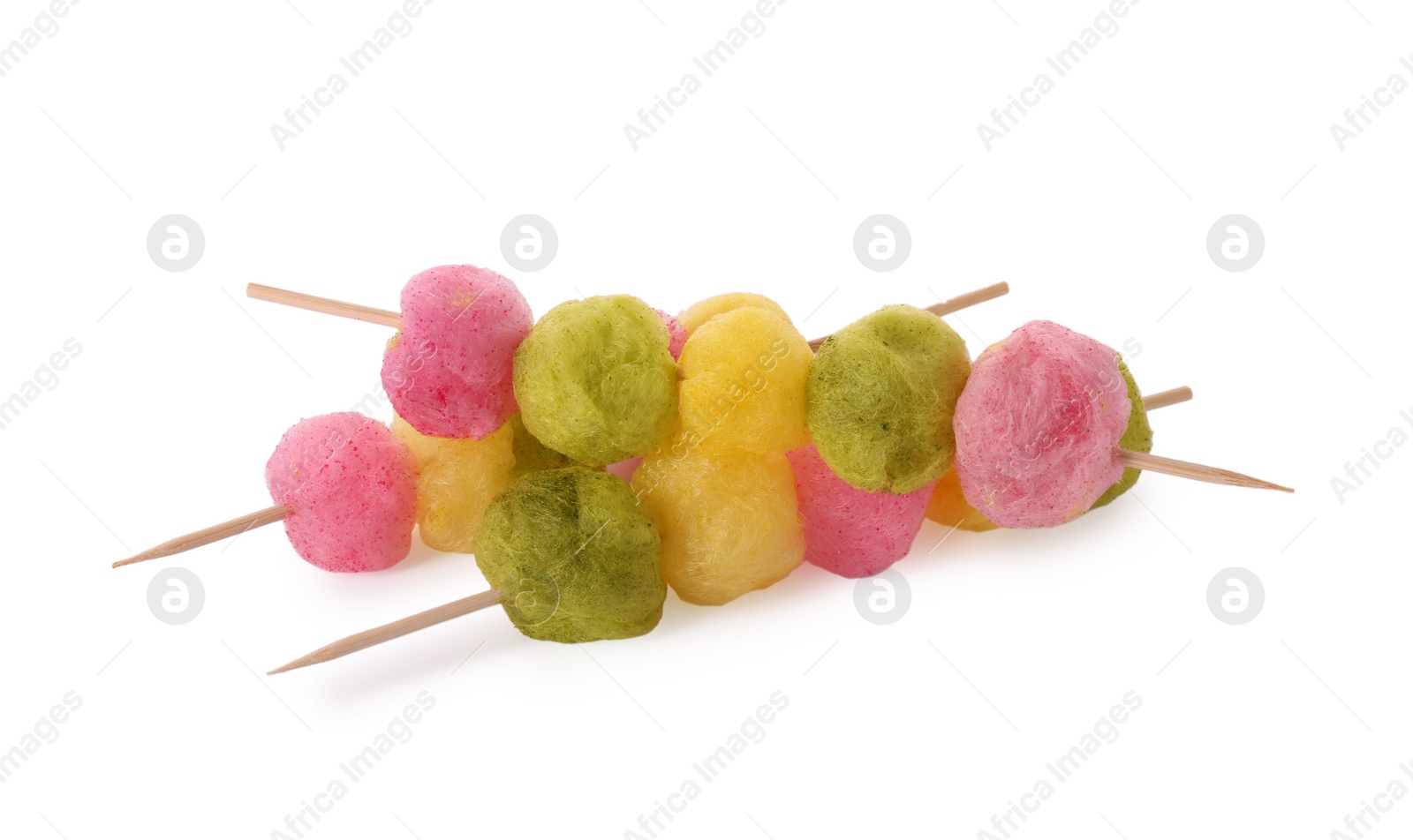 Photo of Skewers with color cotton balls isolated on white. Sweet candy