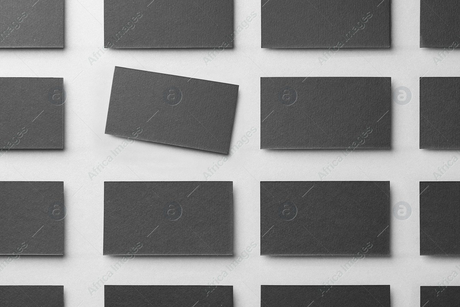 Photo of Blank black business cards on light background, flat lay. Mockup for design