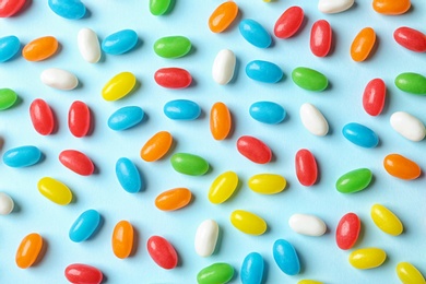 Flat lay composition with delicious jelly beans on color background