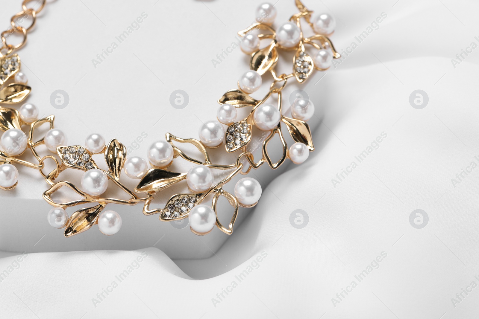 Photo of Beautiful necklace on white background, closeup. Luxury jewelry