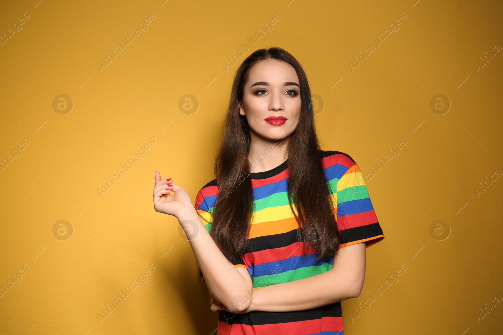 Photo of Portrait of beautiful young woman on colorful background