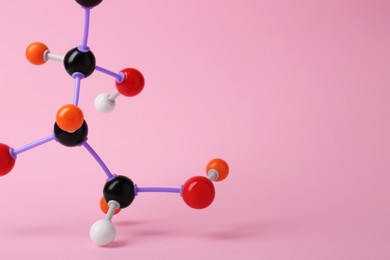 Photo of Molecule of sugar on pink background, closeup with space for text. Chemical model