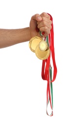 Photo of Man holding golden medals on white background, closeup. Space for design