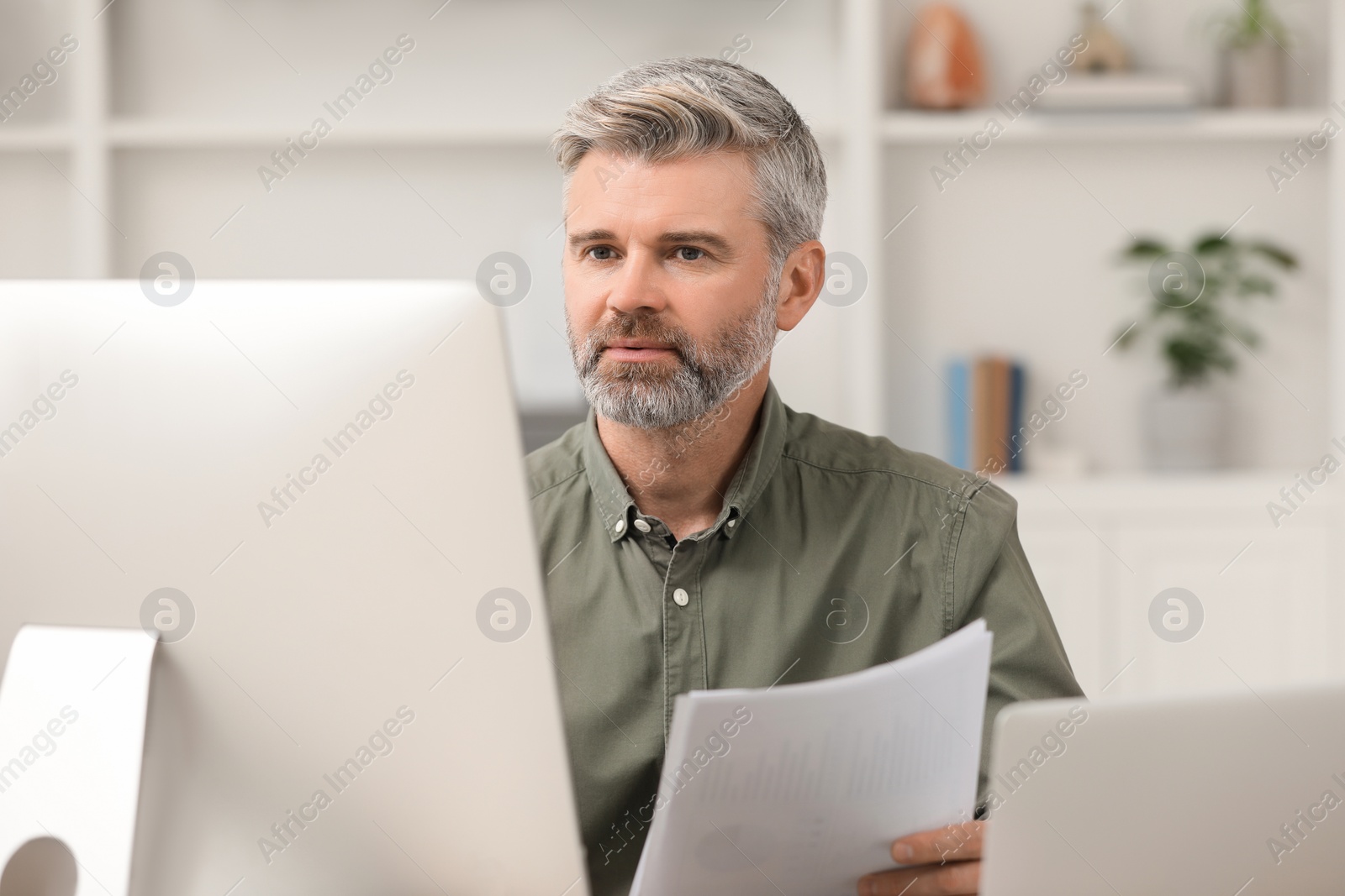 Photo of Professional accountant working on computer in office