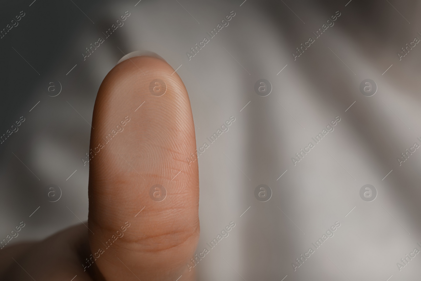 Photo of Woman pressing finger to surface, closeup view. Scanning fingerprint