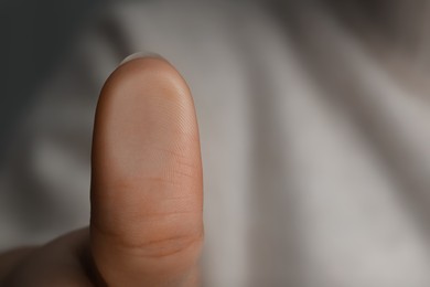 Photo of Woman pressing finger to surface, closeup view. Scanning fingerprint