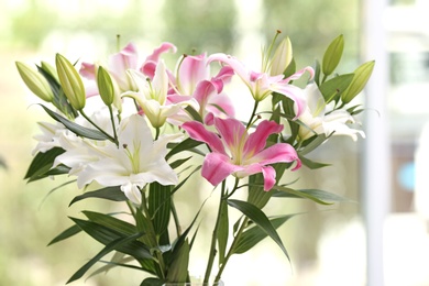 Photo of Bouquet of beautiful lilies on blurred background