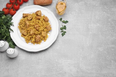 Photo of Delicious rice with chicken served on light grey table, flat lay. Space for text