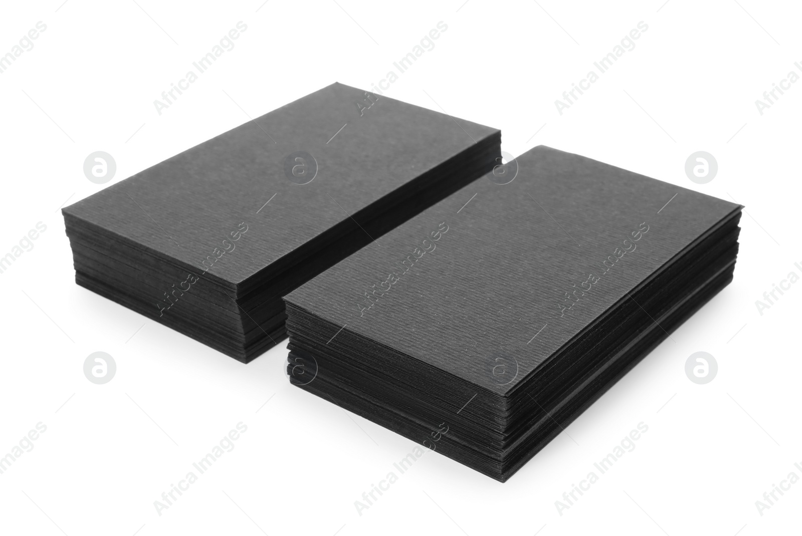 Photo of Stacks of blank black business cards isolated on white. Mockup for design