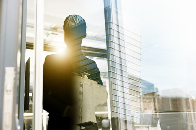 Double exposure of successful businessman and cityscape