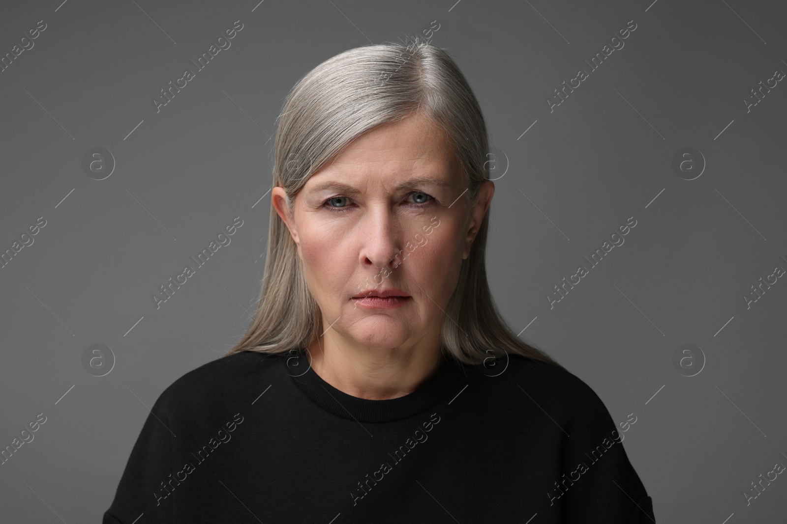 Photo of Personality concept. Portrait of emotional woman on gray background