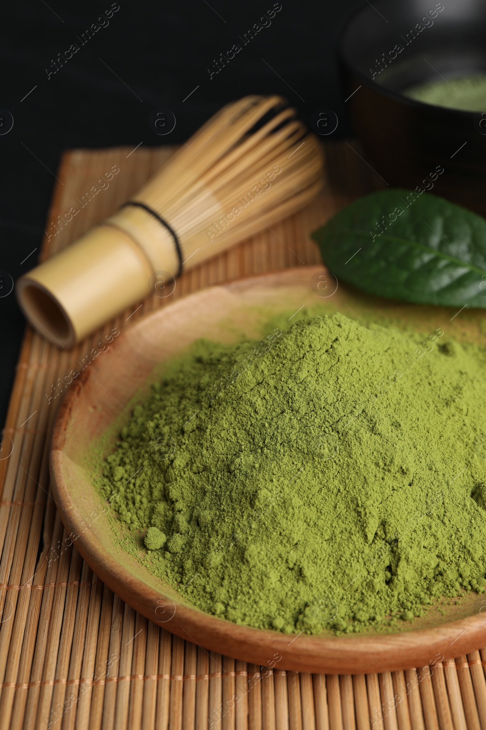 Photo of Green matcha powder on bamboo mat, closeup