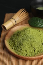 Green matcha powder on bamboo mat, closeup