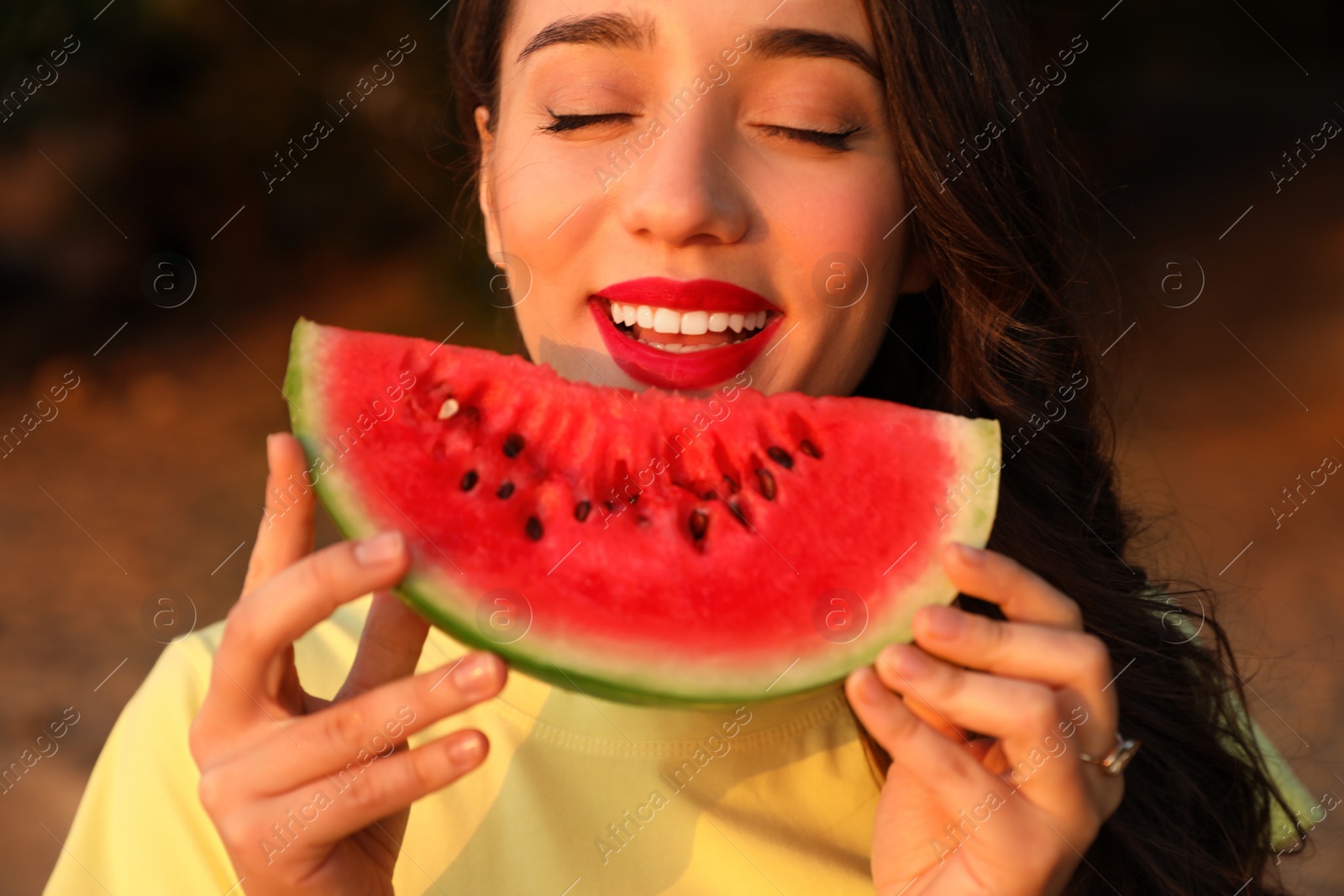 Photo of Beautiful young woman with watermelon outdoors, closeup