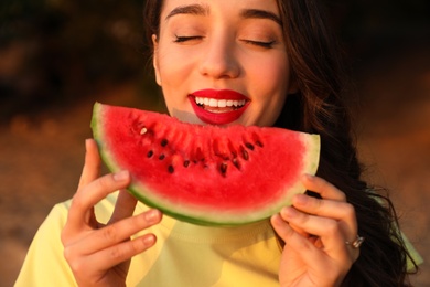 Photo of Beautiful young woman with watermelon outdoors, closeup