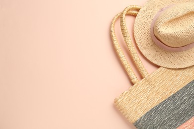 Photo of Straw hat and bag on beige background, flat lay. Space for text
