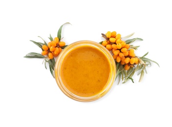 Delicious sea buckthorn jam in jar and fresh berries on white background, top view