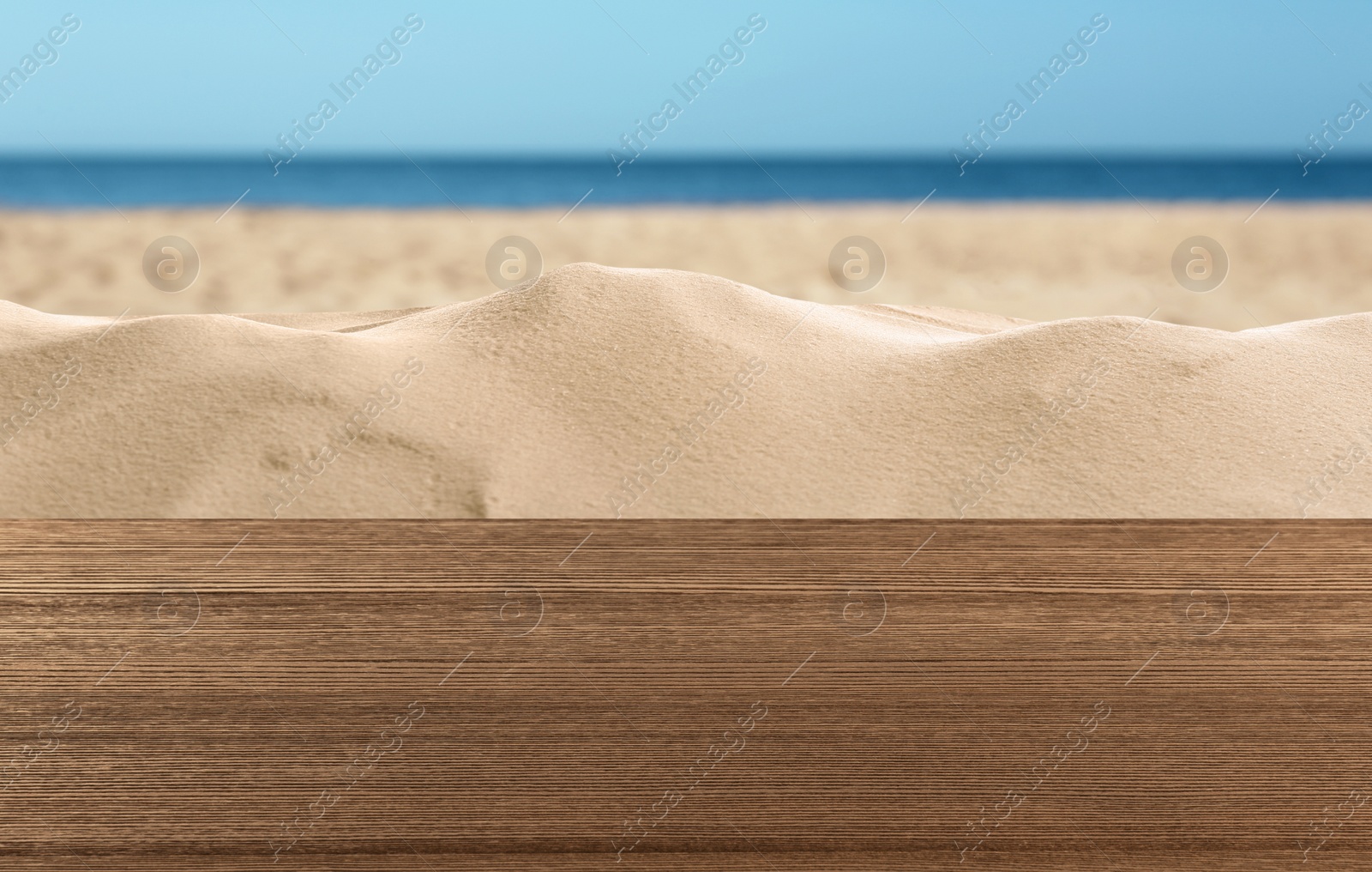 Image of Wooden surface on sandy beach near ocean