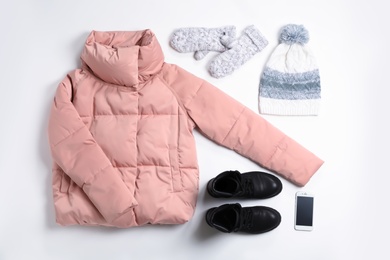 Flat lay composition with female winter clothes on white background