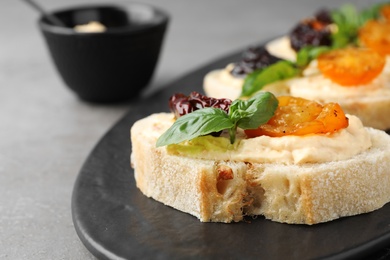 Tasty fresh tomato bruschettas on grey table