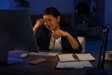 Tired businesswoman working at night in office