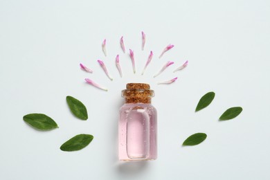 Composition with essential oil, clover petals and leaves on white background, top view