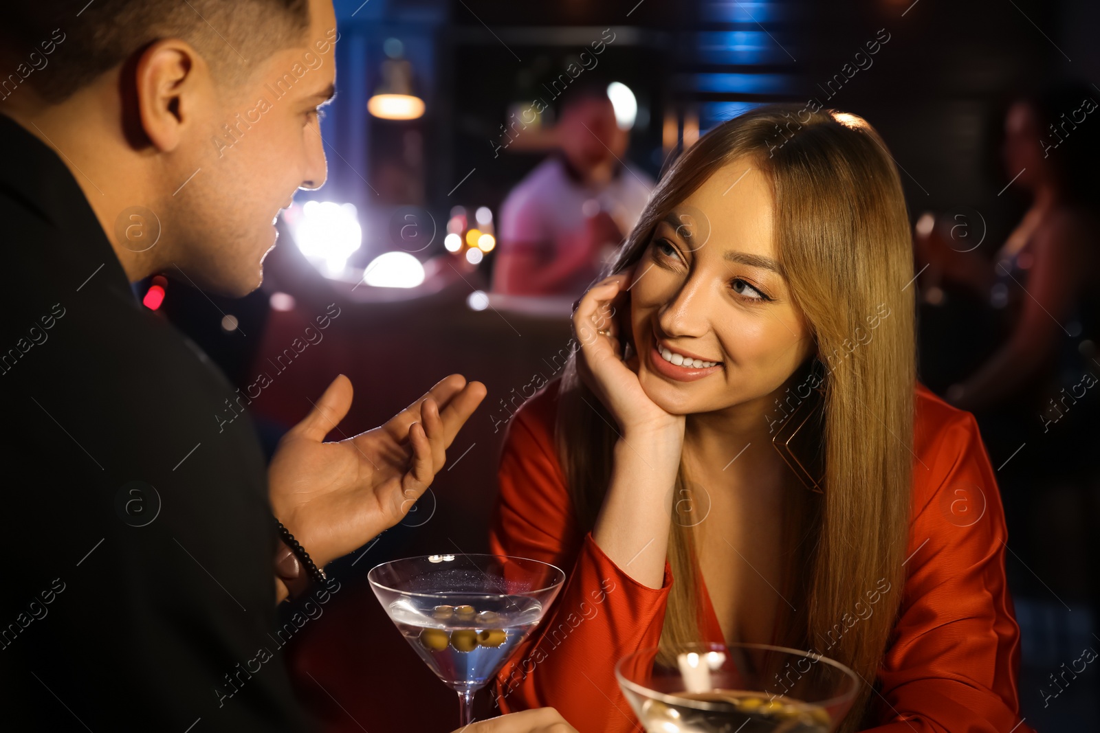 Photo of Man and woman flirting with each other in bar