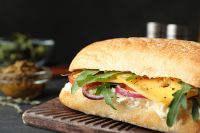 Delicious sandwich with fresh vegetables and cheese on grey table, closeup