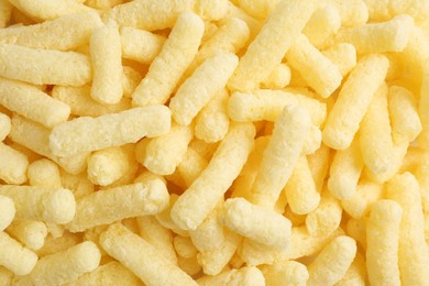 Photo of Tasty sweet corn sticks as background, top view